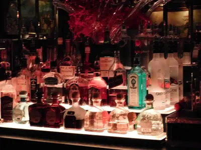 a display of bottles of alcohol on a shelf at West Gate Inn Nyack in Nyack