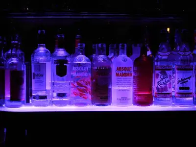 a row of bottles of alcohol on a shelf at West Gate Inn Nyack in Nyack