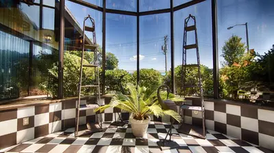 a room with a plant in the middle of a building at West Gate Inn Nyack in Nyack
