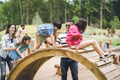 a group of people playing on a wooden bridge at The Kartrite Resort and Indoor Waterpark in Monticello