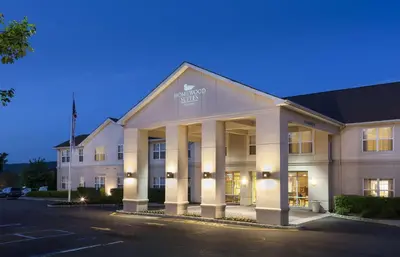 a large white building with columns in a parking lot at Homewood Suites by Hilton Mahwah in Mahwah