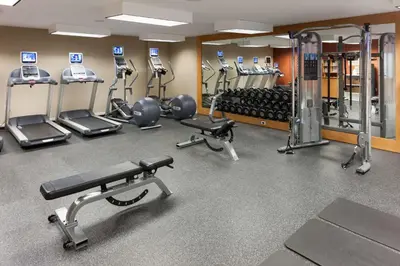 a gym with several treadmills and exercise machines at Homewood Suites by Hilton Mahwah in Mahwah
