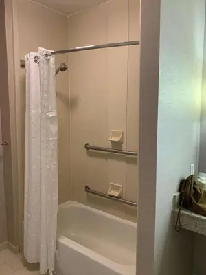 a bathroom with a shower curtain and a bath tub at Homewood Suites by Hilton Mahwah in Mahwah