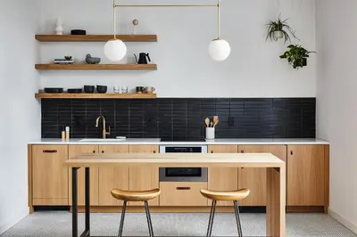 a kitchen with a wooden table and two stools at Lokal Hotel Fishtown in Philadelphia