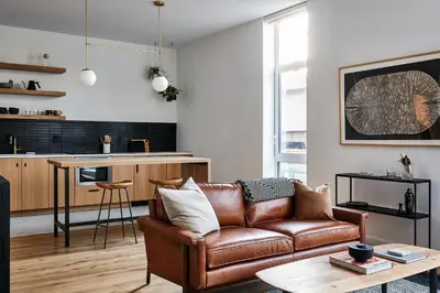 a living room with a couch and a table at Lokal Hotel Fishtown in Philadelphia