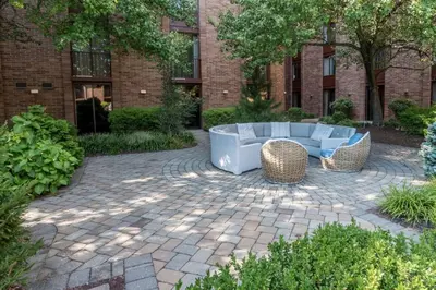 a patio with a couch and chairs in front of a building at Hampton Inn Parsippany in Parsippany