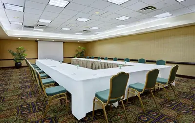 a large conference room with a large white table and chairs at Embassy Suites Parsippany in Parsippany