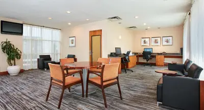 a conference room with a table and chairs at Embassy Suites Parsippany in Parsippany