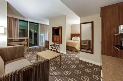 a hotel room with a couch and a bed at Wyndham Garden Chinatown in New York