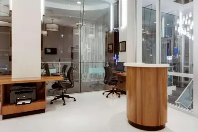 an office with glass walls and desks and chairs at Wyndham Garden Chinatown in New York