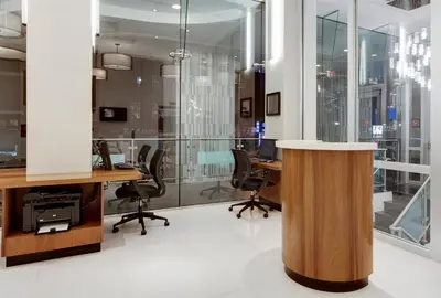 an office with glass walls and desks and chairs at Wyndham Garden Chinatown in New York