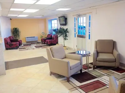 a waiting room with two chairs and a table at Tappan Zee Hotel in West Nyack
