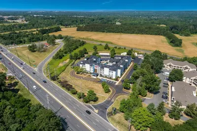 an aerial view of a building next to a highway at Hampton Inn Princeton in Princeton