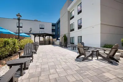 a group of benches sitting outside of a building at Hampton Inn Princeton in Princeton