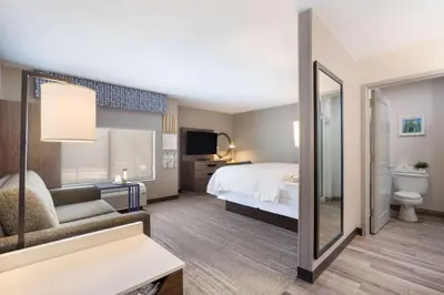 a hotel room with a bed and a mirror at Hampton Inn Princeton in Princeton