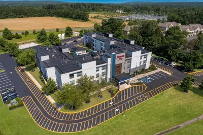 an aerial view of a building with a parking lot at Hampton Inn Princeton in Princeton