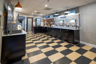 a large kitchen with a checkered floor at Holiday Inn Express - Newark Airport - Elizabeth by IHG in Elizabeth