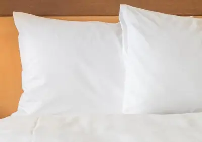 a white bed with white sheets and pillows at Holiday Inn Express - Newark Airport - Elizabeth by IHG in Elizabeth