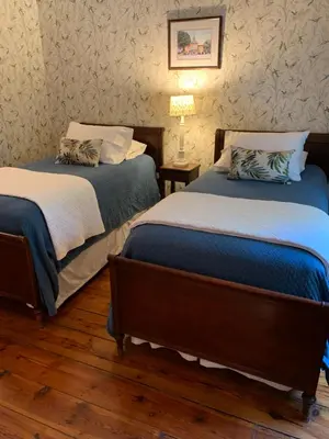 two beds sitting next to each other in a room at The Lily Inn - Burlington in Burlington