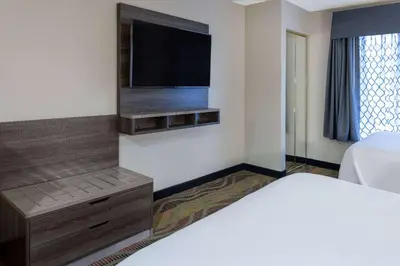 a bedroom with a bed and a flat screen tv at Baymont by Wyndham Budd Lake in Budd Lake