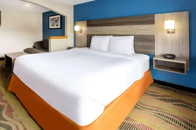 a large white bed in a hotel room at Baymont by Wyndham Budd Lake in Budd Lake
