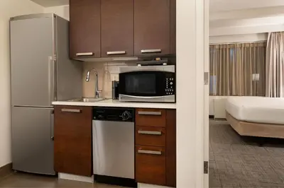 a kitchen with a refrigerator and a microwave at Residence Inn by Marriott New York Manhattan/ Midtown Eastside in New York