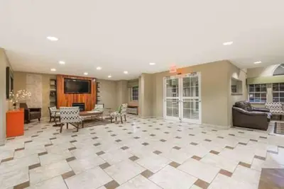 a large living room with a couch and a table at Microtel Inn & Suites by Wyndham West Chester in West Chester