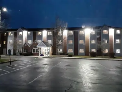 an empty parking lot in front of a large building at Microtel Inn & Suites by Wyndham West Chester in West Chester