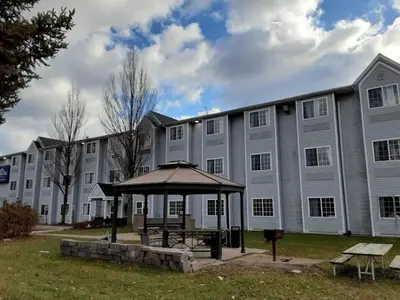 a large building with a gazebo in front of it at Microtel Inn & Suites by Wyndham West Chester in West Chester