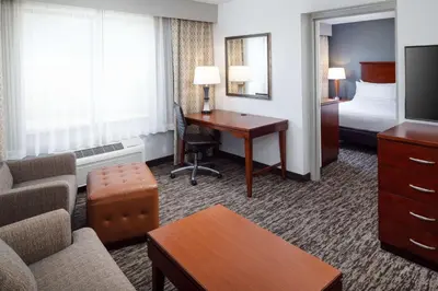 a hotel room with a desk and a bedroom at DoubleTree by Hilton Princeton in Princeton