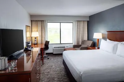 a hotel room with a bed and a desk and a television at DoubleTree by Hilton Princeton in Princeton