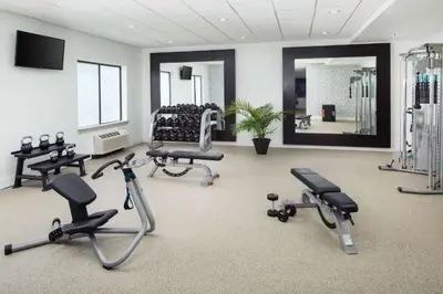 a gym with several exercise bikes and a mirror at DoubleTree by Hilton Princeton in Princeton