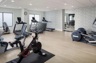 a gym with treadmills and exercise bikes in it at DoubleTree by Hilton Princeton in Princeton