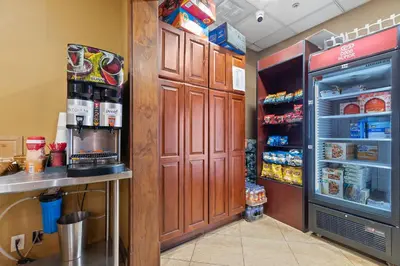 a kitchen with an open refrigerator next to a counter at Hotel Executive Suites in Carteret