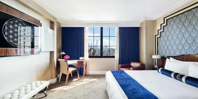 a hotel room with a bed and a desk at Walker Hotel Greenwich Village in New York