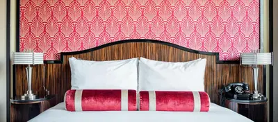 a bedroom with a bed with a red and white headboard at Walker Hotel Greenwich Village in New York