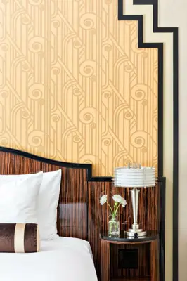 a bedroom with a bed with a side table with a lamp at Walker Hotel Greenwich Village in New York