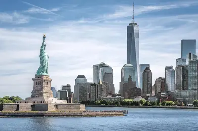 the statue of liberty in front of a city skyline at Holiday Inn Express Manhattan Midtown West by IHG in New York