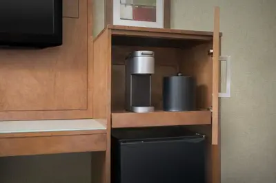 a small kitchen with a cupboard with a appliance in it at Holiday Inn Express Manhattan Midtown West by IHG in New York