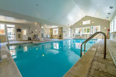 a large swimming pool with a slide in a building at Residence Inn by Marriott Woodbridge Edison/Raritan Center in Woodbridge