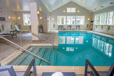 a pool in a hotel room with a swimming pool at Residence Inn by Marriott Woodbridge Edison/Raritan Center in Woodbridge