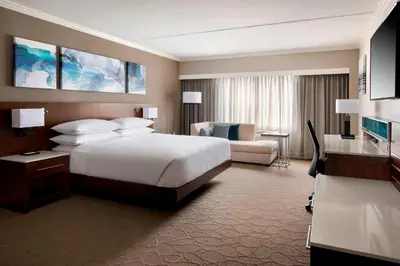a large hotel room with a bed and a couch at Delta Hotels by Marriott Basking Ridge in Basking Ridge