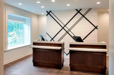 a lobby with two desks and a window at Delta Hotels by Marriott Basking Ridge in Basking Ridge