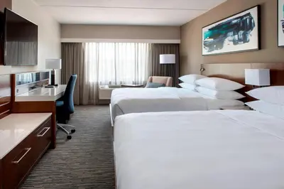 a hotel room with two beds and a desk at Delta Hotels by Marriott Basking Ridge in Basking Ridge