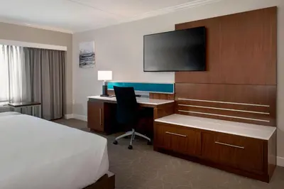 a hotel room with a bed and a desk with a computer at Delta Hotels by Marriott Basking Ridge in Basking Ridge