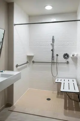 a bathroom with a shower and a sink at Delta Hotels by Marriott Basking Ridge in Basking Ridge