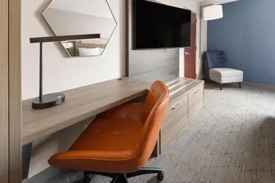 a room with a desk with a chair and a television at Holiday Inn Express Philadelphia Penn's Landing by IHG in Philadelphia