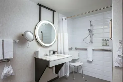 a bathroom with a sink and a mirror at Somerset Hills Hotel, Tapestry Collection by Hilton in Basking Ridge