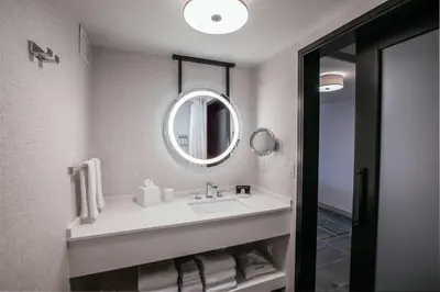 a bathroom with a sink and a mirror at Somerset Hills Hotel, Tapestry Collection by Hilton in Basking Ridge