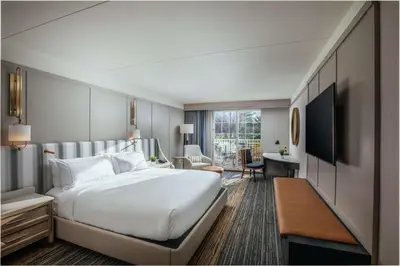 a hotel room with a large bed and a desk at Somerset Hills Hotel, Tapestry Collection by Hilton in Basking Ridge
